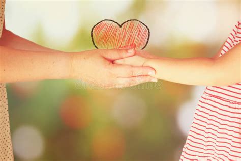 Mother And Child Holding Hands Over Blurred Background Stock Image