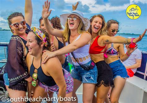 A Group Of Women On A Boat With Their Arms In The Air