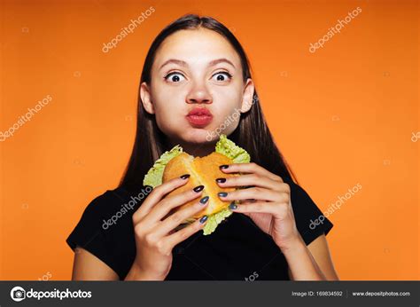 Beautiful Hungry Girl Greedily Eats Up Her Burger And Looks At The Camera Isolated Tasty Food
