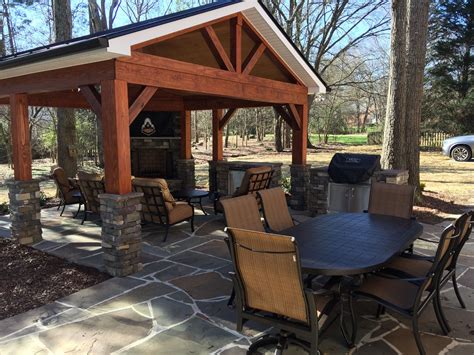 Rustic Covered Patio With Outdoor Fireplace And Flagstone Patio By