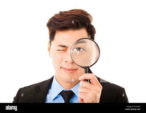 Businessman looking at camera through a magnifying glass - CareerZot