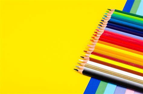 Set Of Colored Pencils For Schoolboy On Bright Background Stock Photo