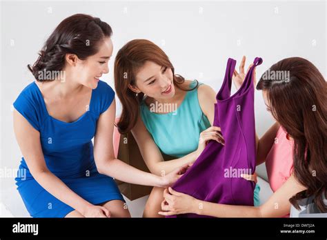 A Group Of Women Admiring A New Dress Stock Photo Alamy