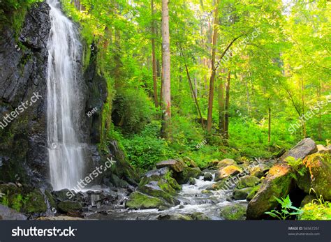 Beautiful Waterfall In Green Forest Scenery From