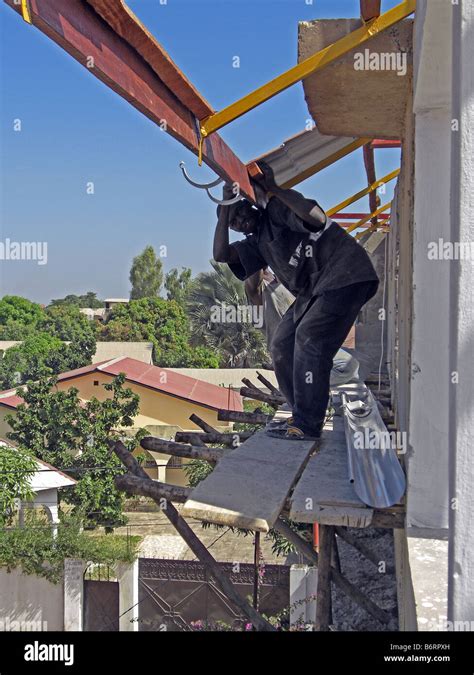 Unsafe Work Practice On A Building Site In The Gambia West Africa Stock