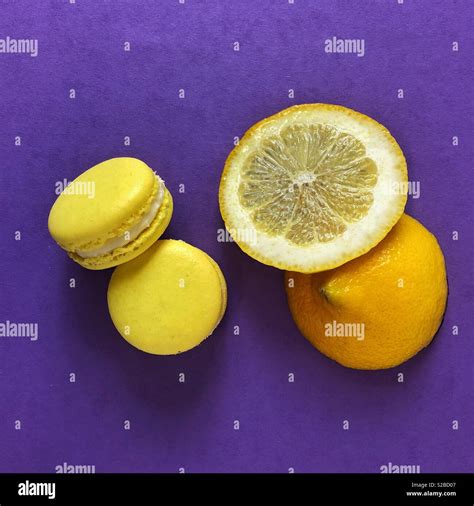 Lemon Meringue Macaroons And Lemon Slice On Purple Background Stock