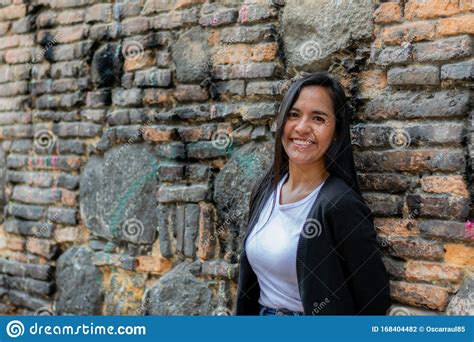 Beautiful Colombian Woman Lying On A Brick Wall Stock Photo Image Of
