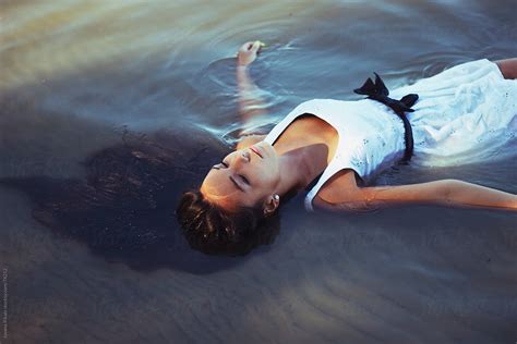 Beautiful Young Girl Laying In Water Relaxing By Stocksy Contributor Jovana Rikalo Stocksy