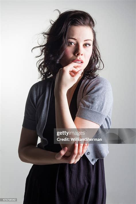 Sultry Brunette Posing With Fingers Stroking Her Lips High Res Stock
