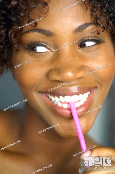 Close Up Of African Woman Drinking Through Straw Stock Photo Picture