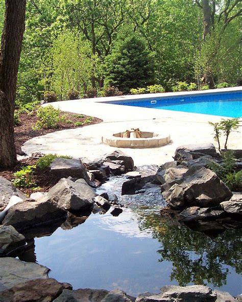 Excellent customer care · rewards program Flagstone patio near pool deck, stone fire pit, and ...