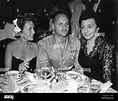 DARRYL F. ZANUCK (center), on leave from WWII duties, flanked by wife ...