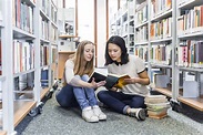 US Nanny Institute » Two teenage girls sitting on the floor in a public ...