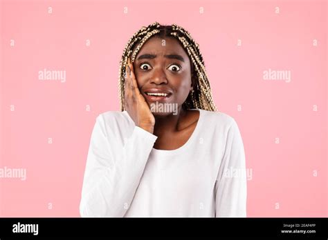 Portrait Of Nervous Scared African American Woman Grabbing Face Stock