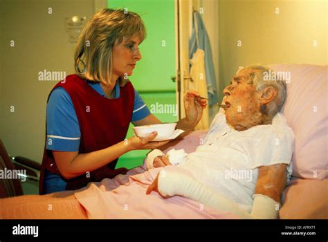 Nurse In Care Home Feeding An Elderly Woman Resident Nursing An Old Are Pensioner Oap Homer