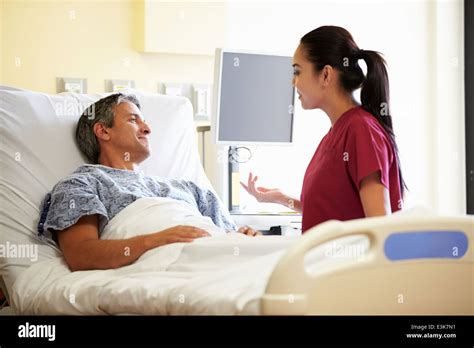 Nurse Talking To Male Patient In Hospital Room Stock Photo Alamy