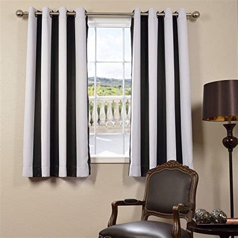 Black And White Striped Curtains Hanging In Front Of A Window With A