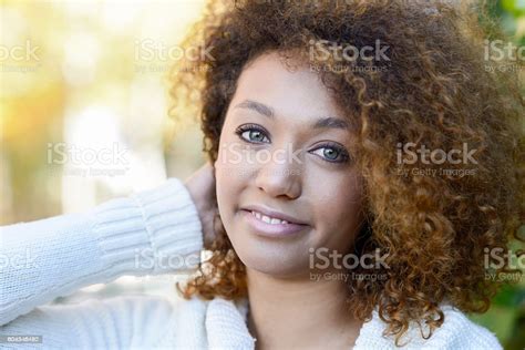 Young African American Girl With Afro Hairstyle And Green Eyes Stock