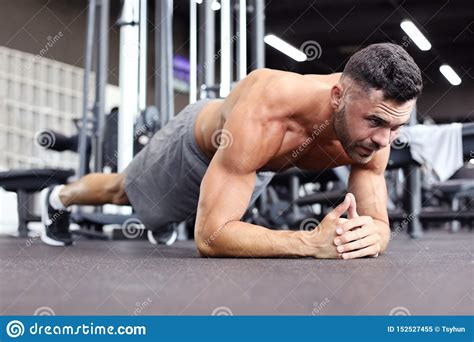 Portrait Of A Fitness Man Doing Planking Exercise In Gym Stock Image