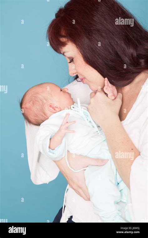 Mom Is Feeding The Baby Milk From A Bottle Stock Photo Alamy