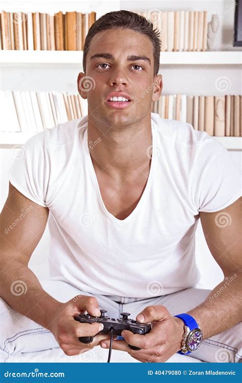 Attractive Guy Concentrating While Playing Video Games Stock Photo