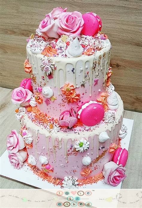 Love heart silhouette engagement cake. 2-tier drip engagement cake with macrons and fresh flowers ...