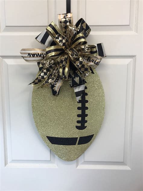 Loving this black and gold Christmas football door hanger! | Dallas