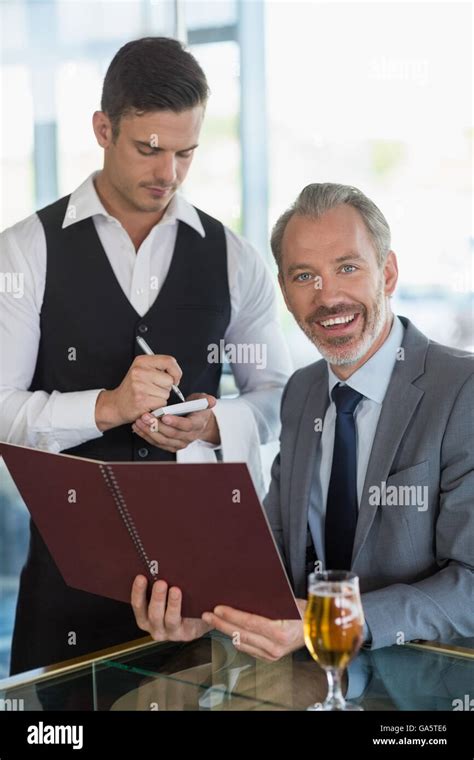 Waiter Taking The Order From A Businessman Stock Photo Alamy