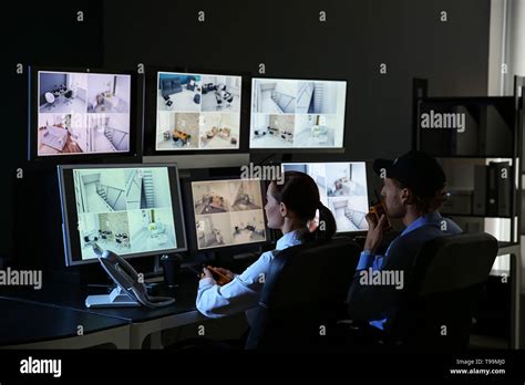 Security Guards Monitoring Modern Cctv Cameras In Surveillance Room