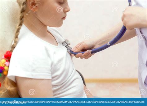 Female Doctor Examining A Child With Stethoscope Close Up Stock Image