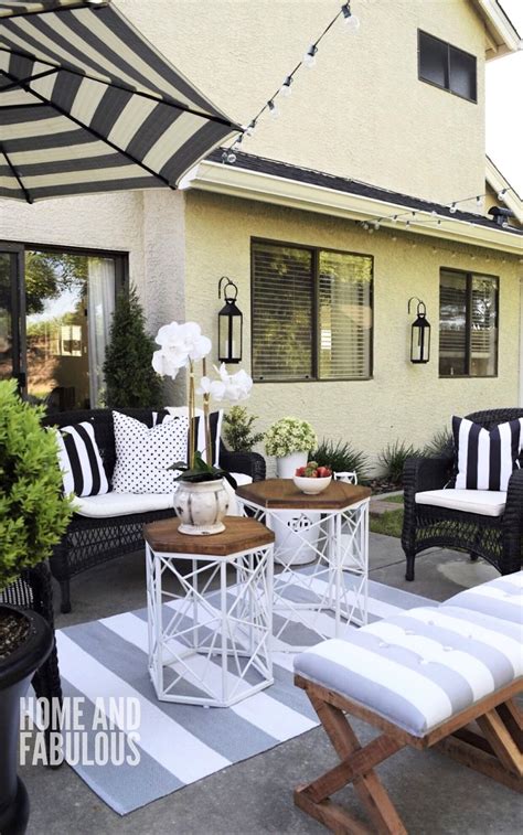 Black outdoor umbrella provides shade to wrought iron pool loungers accented with black border outdoor pillows. Pin on garden outdoor rooms