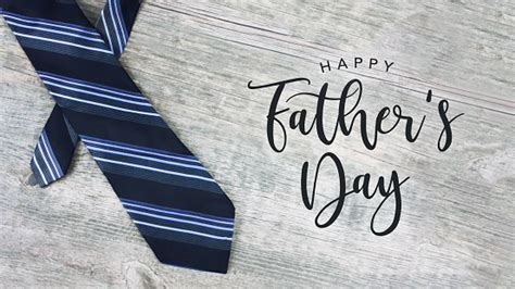 Father's day is celebrated worldwide to recognize the contribution that fathers and father figures make to the lives of their children. Happy Fathers Day Text With Striped Tie Over Wood ...