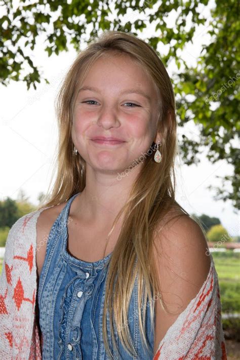 Cute Blonde Teen Girl Smiling In Grass — Stock Photo © Oceanprod
