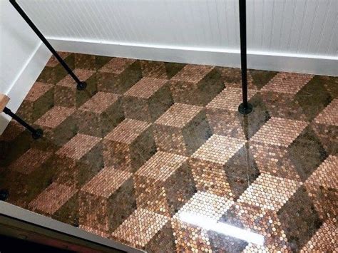 A Tiled Floor With Black And Brown Tiles On It In Front Of A White Wall
