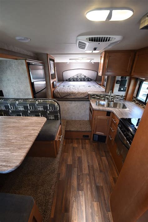 The Interior Of An Rv With Wood Flooring