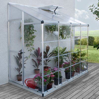 A Small Greenhouse With Plants In It