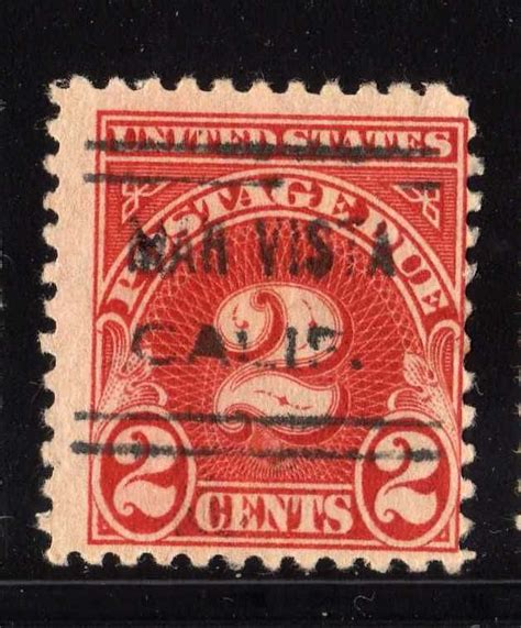 An Old Red And Black Stamp With The Image Of A Bird On It