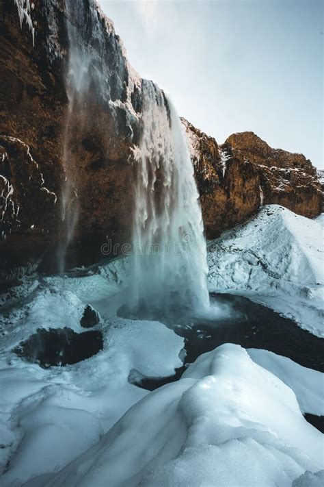 Seljalandsfoss Waterfall In Iceland During Winter With Blue Sky And