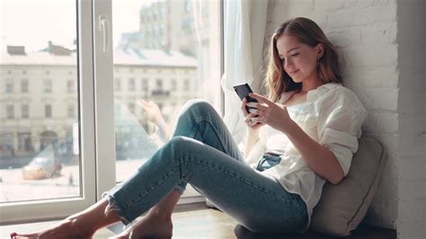 Young Woman Sitting On Windowsill At Home Stock Footage Sbv 337628185 Storyblocks