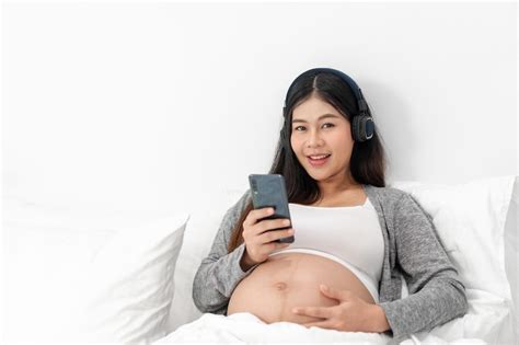 Premium Photo Asian Happy Pregnant Woman Is Sitting On Bed And And