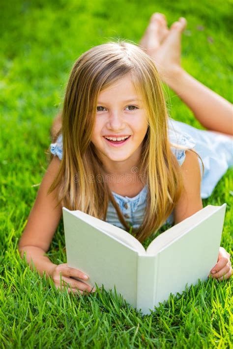 Cute Little Girl Reading Book Outside On Grass Stock Photo Image Of