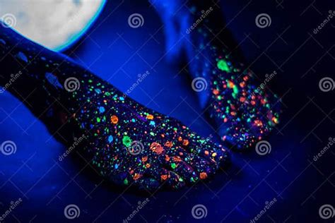 Barefoot Female Feet In A Spray Of Paint Glowing In The Dark Toes In