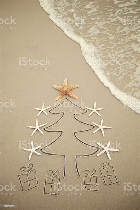Sand Christmas Tree With Cute Presents On The Beach Stock Photo