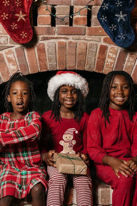 Three Black Girls Wearing Christmas Pajamas By Stocksy Contributor