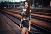 A beautiful slim model girl is standing by the railroad wallpapers and ...