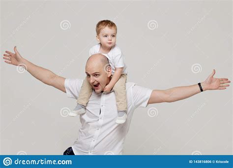 Father And His Son The Young Man Raising Children The Concept