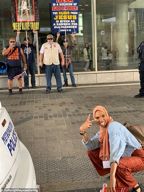 smiling woman in hijab flashing peace sign in front of anti muslim protesters goes viral daily