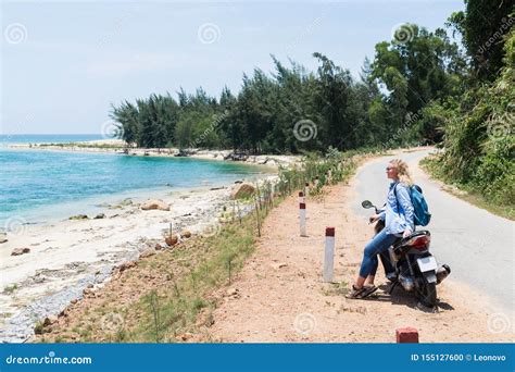 Woman Riding Motorcycle Along The Sea On The Road To Hai Van Pass