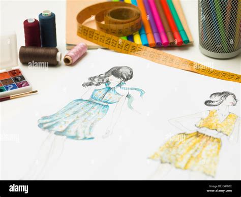 Closeup Of Fashion Designer Workspace With Sketches And Designing