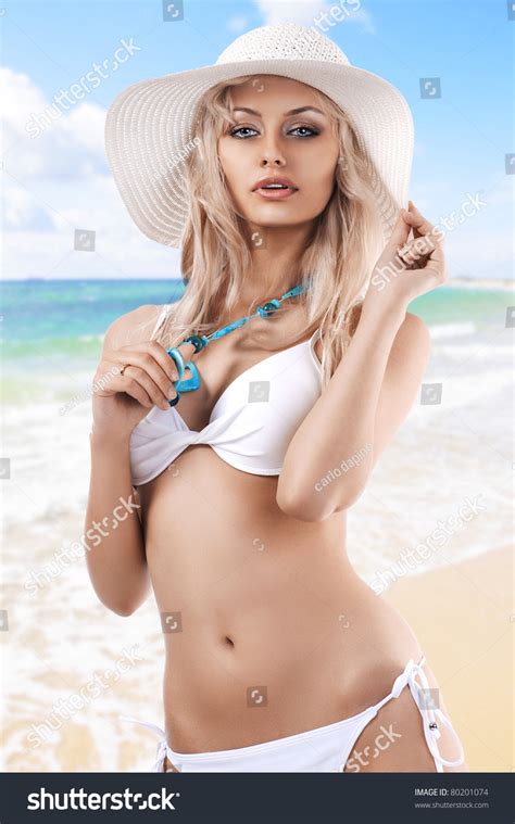 Sexy Beautiful Blond Girl In White Swimsuit Bikini Posing With A Big